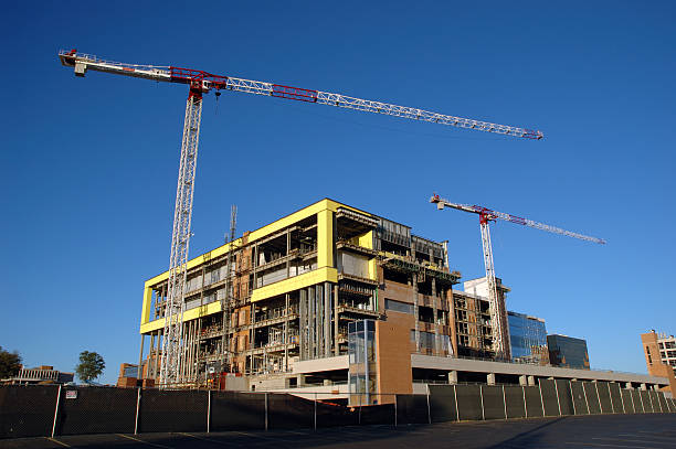 Building Under Construction with Two Cranes stock photo