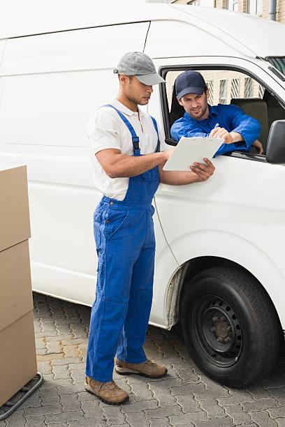 istock Delivery driver showing customer where to sign 471075798