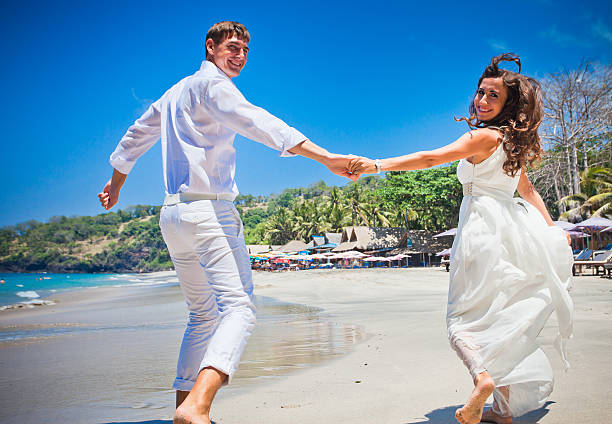 istock Happy couple just married and running on the beach 471075844