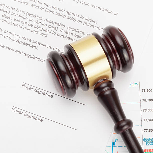 istock Wooden judge's gavel over unsigned contract - close up shot 471075908