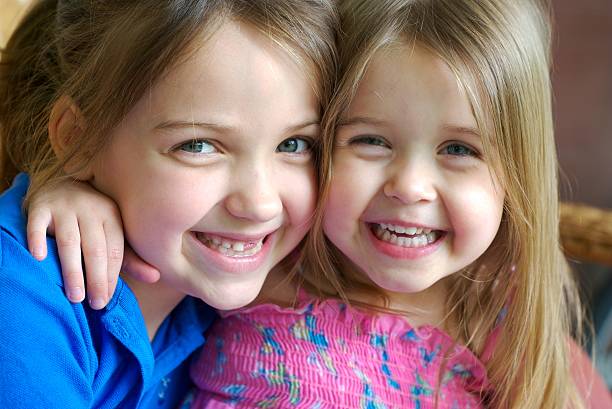 istock Big and Little Sister Loving Each Other 471076061