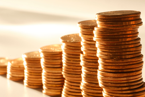 A stack of U.S. pennies representing growth. Shot with shallow depth of field.