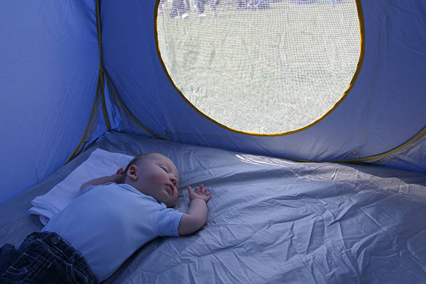 istock baby boy asleep in tent 471077265