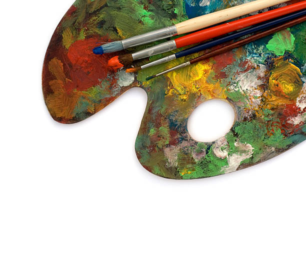 istock Artist's messy palette with four colored brushes 471077543
