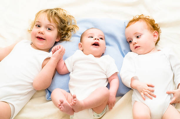 istock 2 babies and 1 toddler laying down 471077729
