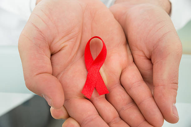 istock Person Holding Aids Ribbon 471078230