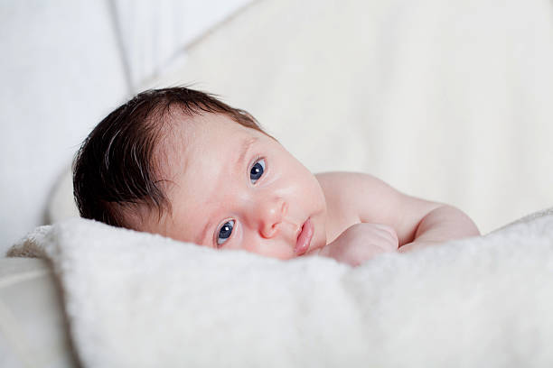 istock new born baby lie on the bed 471079244