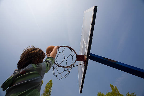 istock Basketball hoop and boy score 471079389