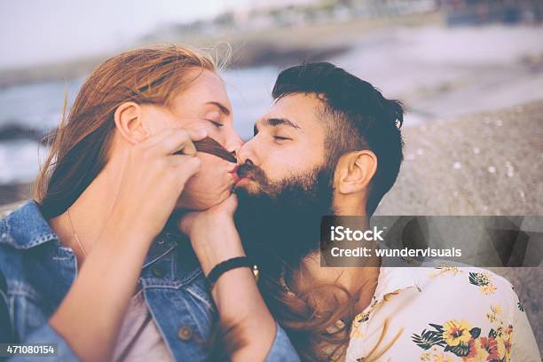 Cute Hipsters Kissing At The Beach Stock Photo - Download Image Now - 2015, Adult, Affectionate