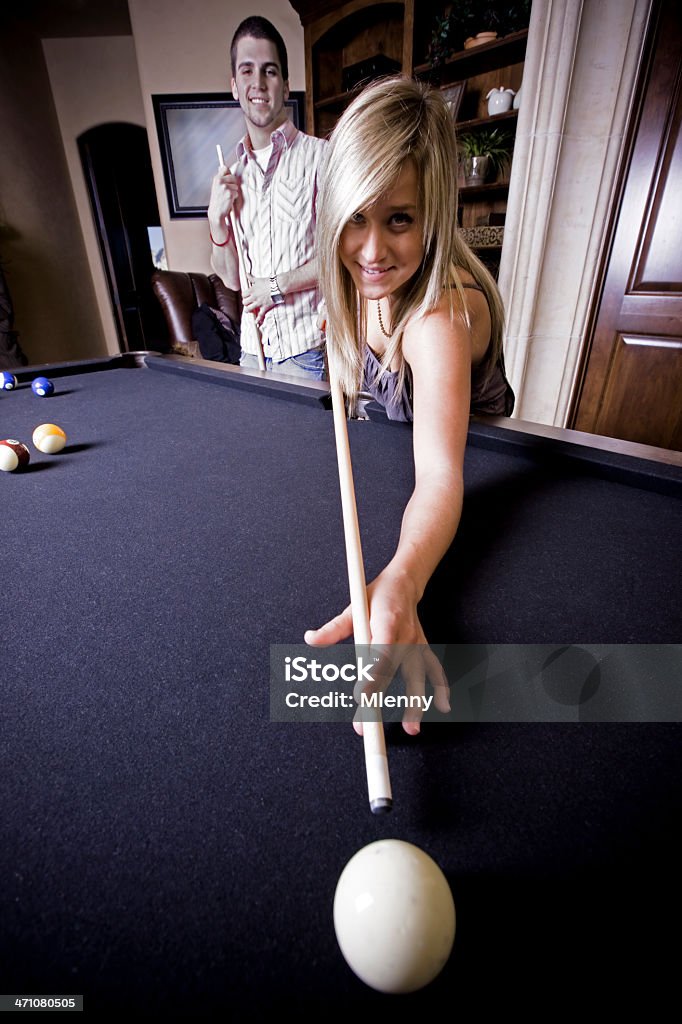 Playing Pool Blonde Girl having fun playing pool billiard together with her boyfriend. Leisure Activity Couple Portrait. 20-24 Years Stock Photo