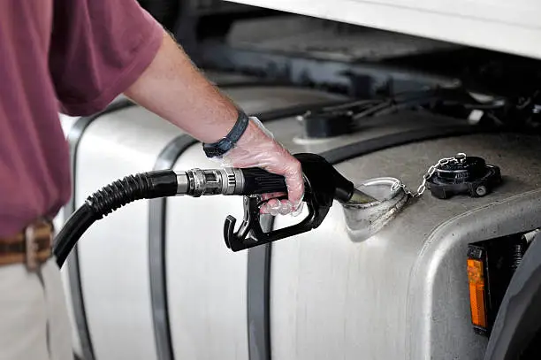 Photo of Man filling up the gas tank with gasoline
