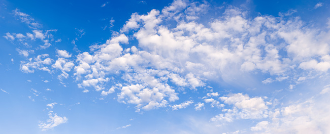 Beautiful fluffy clouds on blue sky. Full resolution jpeg is extremely large and measures 17777x7254 pixels (128 megapixels).