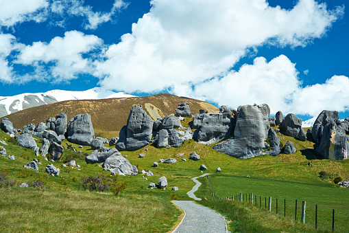 A footpath snakes and undulates its way towards the grand tourist attraction that is Castle Hill in New Zealand. This great limestone formation sits in Arthur's Pass on New Zealand's South Island, and is something for a Mecca for photographers, tourists and rock climbers alike. Often you'll find climbers practicing their techniques on some of the smaller rocks.