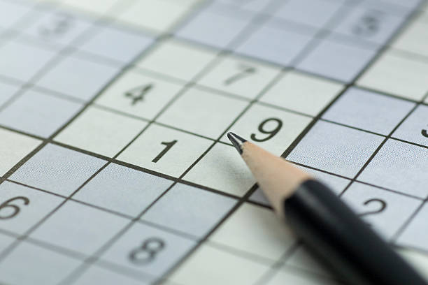 Beginner difficulty incomplete sudoku and a sharp pencil stock photo
