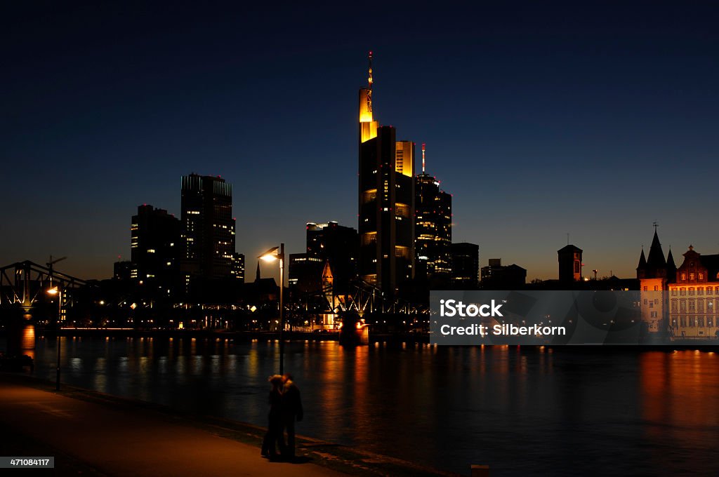 Frankfurt Night shot of Frankfurt / Main skyline at "Eiserner Steg", a couple kissing beneath a lantern (motion blur) Bridge - Built Structure Stock Photo