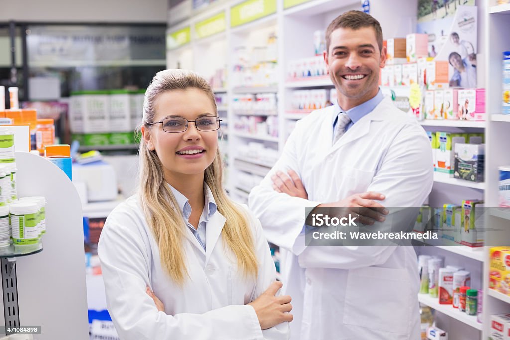 Team of pharmacists smiling at camera Team of pharmacists smiling at camera at the hospital pharmacy 20-24 Years Stock Photo