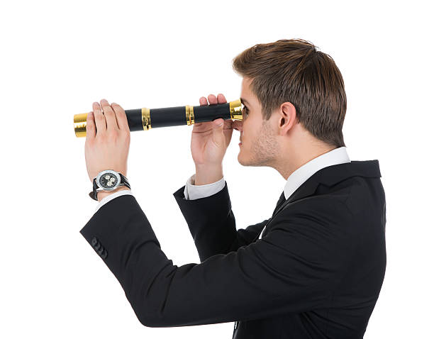 istock Young Businessman Looking Through Handheld Telescope 471084974