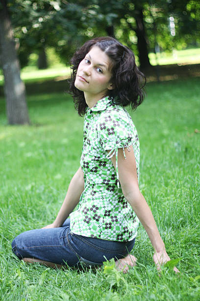 Cute teenage girl resting in park stock photo