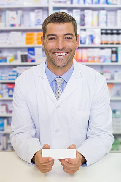 istock Handsome pharmacist holding medicine box 471085094