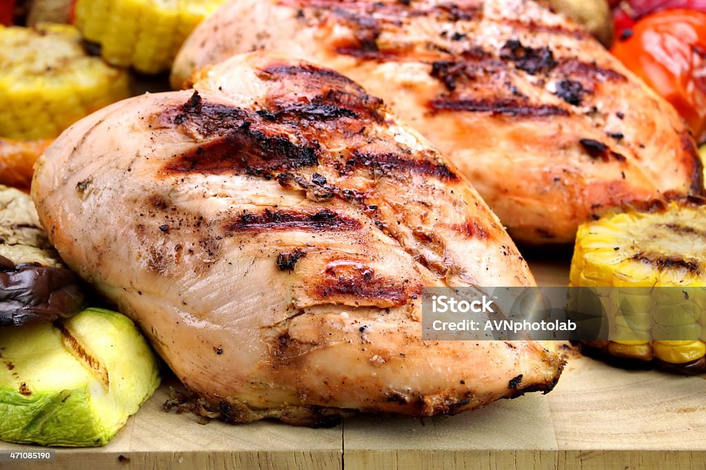 Grilled Chicken White Meat And Vegetables Close-Up Grilled Chicken White Meat And Vegetables On Wood Cutting Board Close-Up Char-Grilled Stock Photo