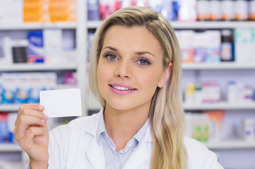 Pharmacist showing medicine box at the hospital pharmacy