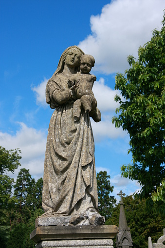 weatherbeaten and partly demolished statue seen at Dublin cemetary - figurine showing 