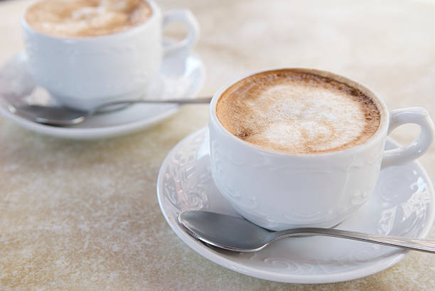 istock Pair of Fresh Cappuccinos Stone Table 471088149