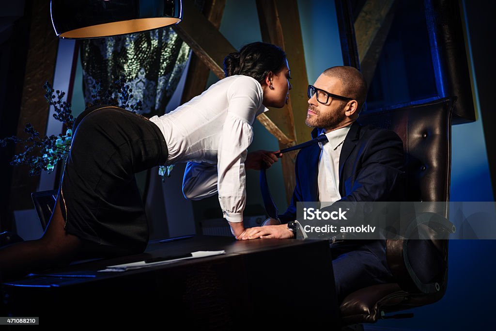 Couple indoors Couple indoors. Sensual brunette seduces handsome businessman. Office romance concept 2015 Stock Photo