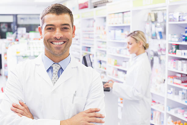 istock Smiling pharmacist standing with arms crossed 471088242