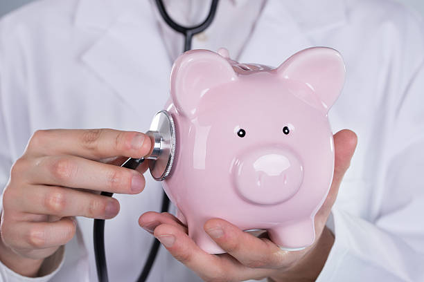 istock Doctor examining pink piggyback with stethoscope 471089286