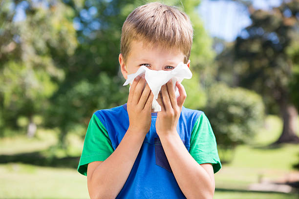 istock Little boy blowing his nose 471089306