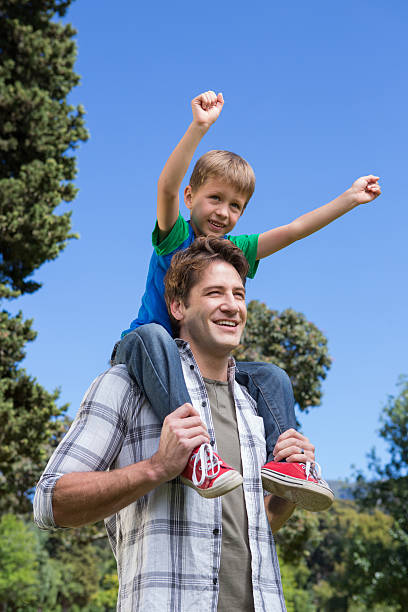 istock Father and son having fun in the park 471089478