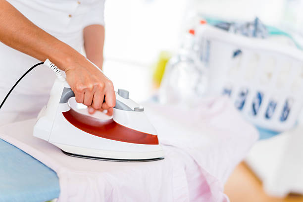 istock Ironing clothes at home 471089566