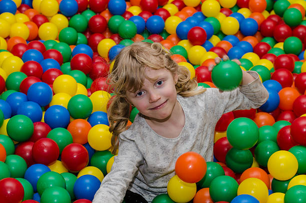 istock happy girl playing with balls 471089688