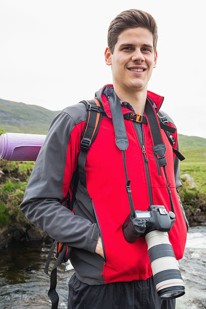 istock Happy man on a hike with amera around his neck 471089704