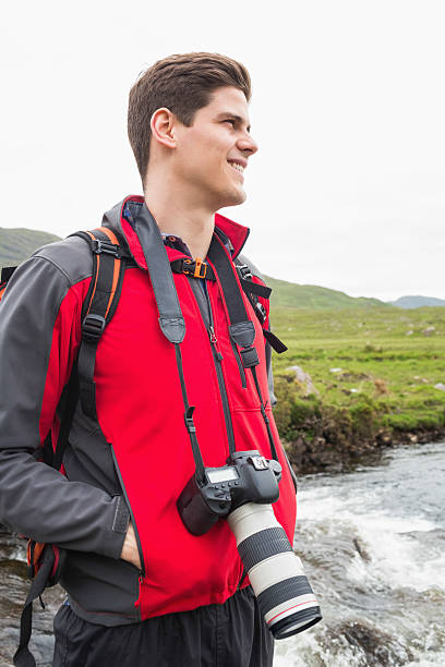 istock Brunette man on hike withcamera around his neck 471089710