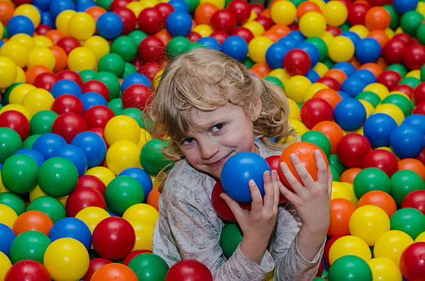 istock happy girl playing with balls 471089712