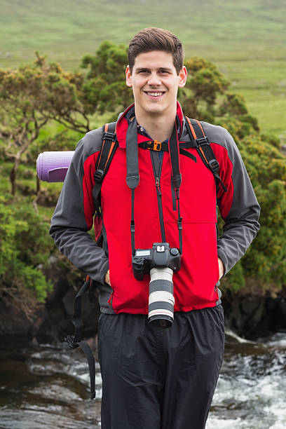 Handsome man on hike with camera around his neck