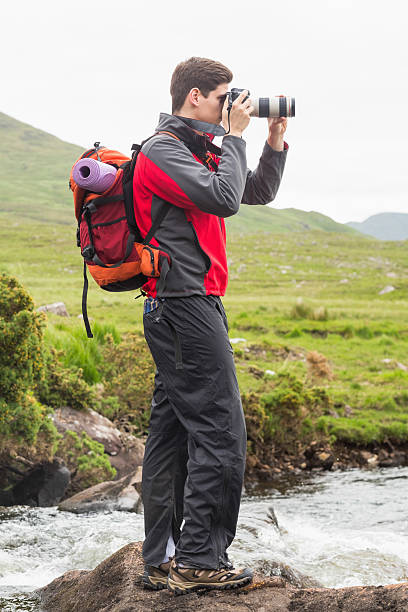 istock Handsome man on hike taking a photo 471089836