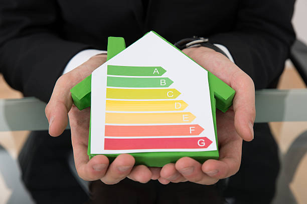 istock Businessman Showing Energy Efficient Chart On House Model 471090448