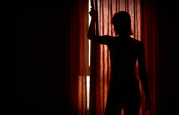 istock Woman Hiding Behind Curtains 471091409