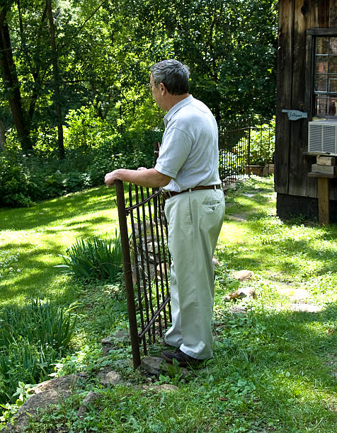 Senior man at gate looking forward stock photo