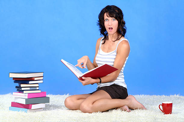 istock Suprised woman and book 471092293