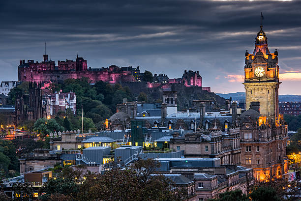 castelo de edimburgo e a cidade à noite, escócia, reino unido - edinburgh scotland castle skyline - fotografias e filmes do acervo