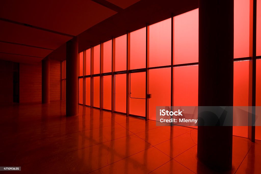 Modern Architecture Entrance Hall Modern architecture entrance hall with shiny red glass facade - windows illuminated from the outdoor sunlight. Abstract Stock Photo