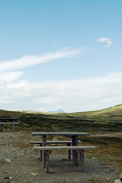istock Wooden table along the road for coffee break in mountains. 471094337