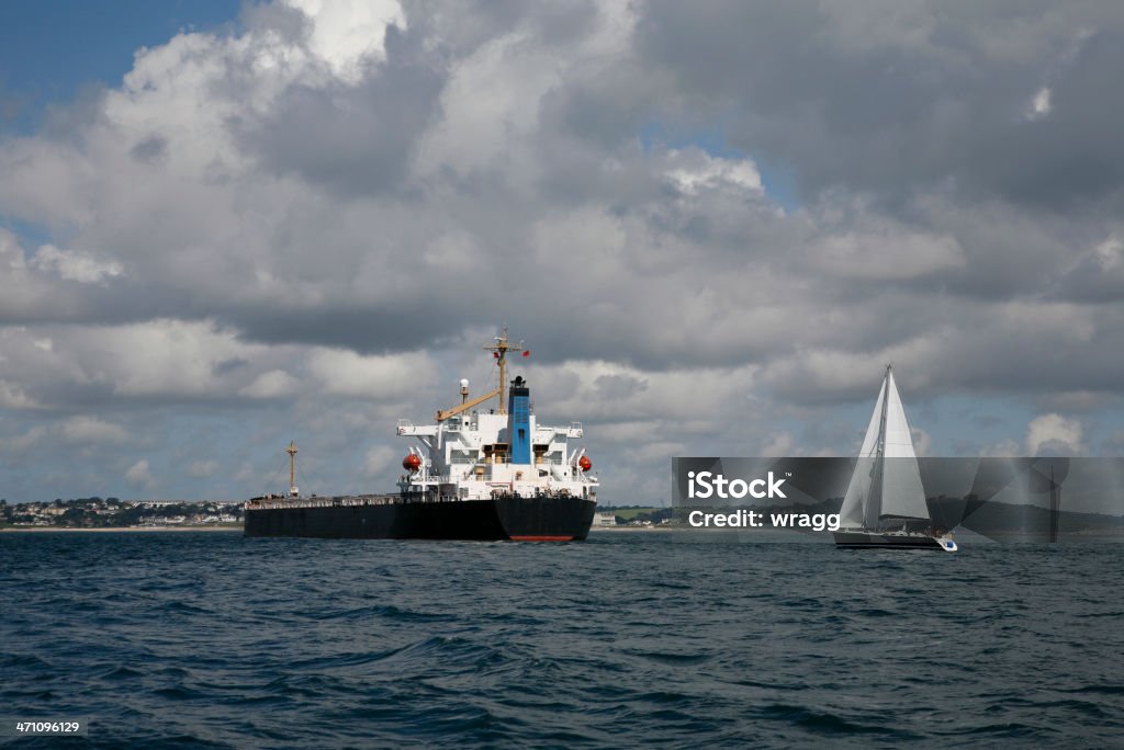 Ships for Business and Pleasure Sailing yacht and Tanker Arrival Stock Photo