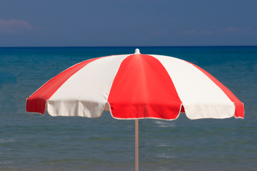 Blue and white stripe umbrella on the beach
