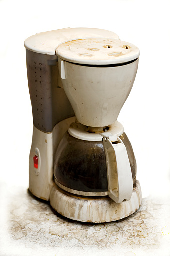 A very used and dirty coffee machine isolated.