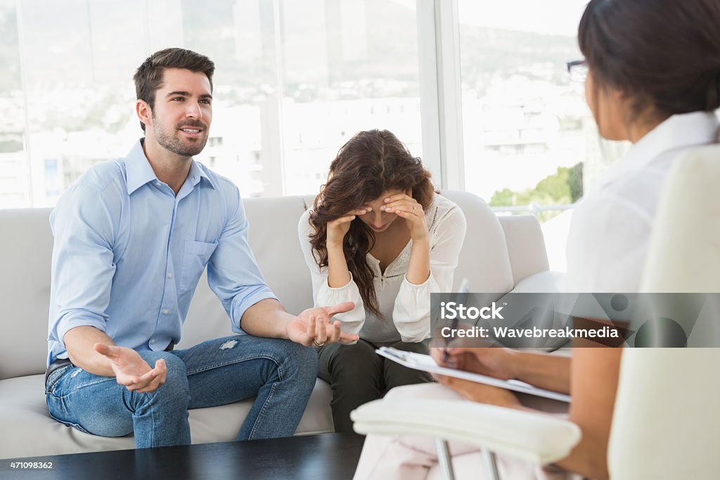 Couple fighting together in front of their therapist Couple fighting together in front of their therapist in the office 20-24 Years Stock Photo